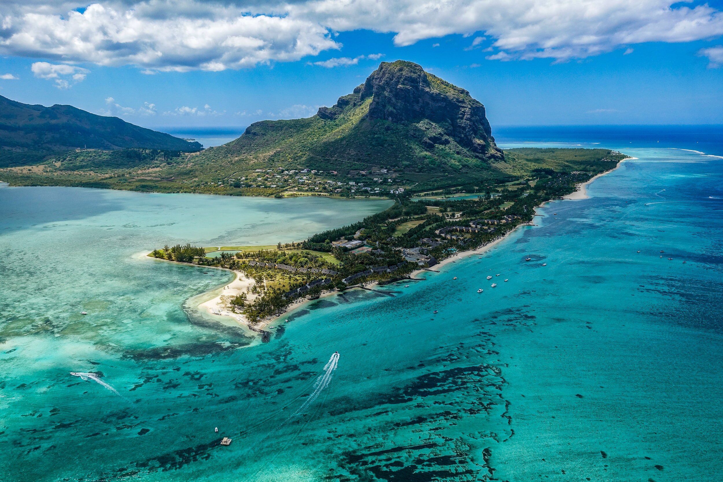 A birds eye view of Mauritius surrounded by turquoise water.