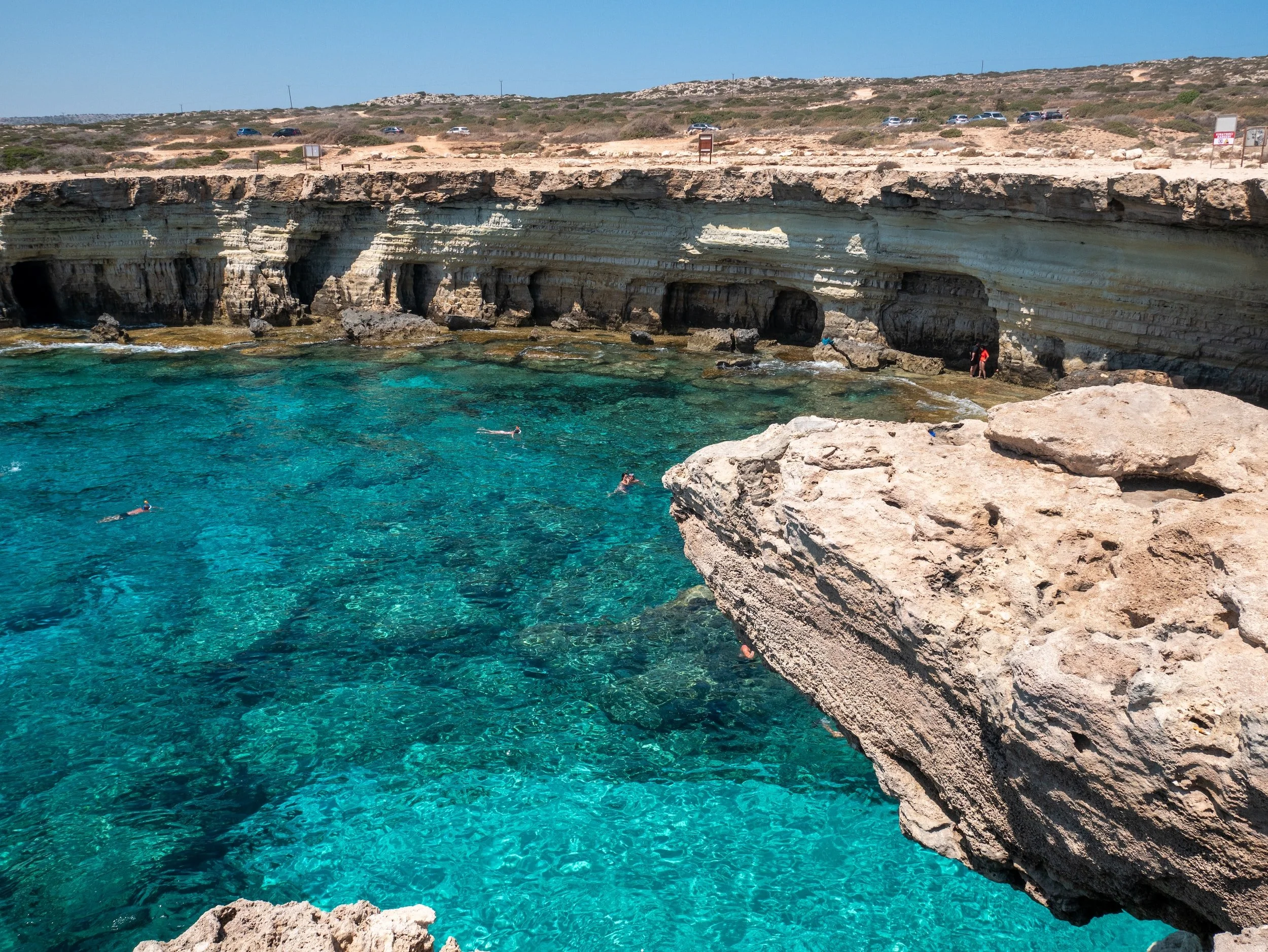 Crystal clear blue mediterranean water surrounded by cliffs