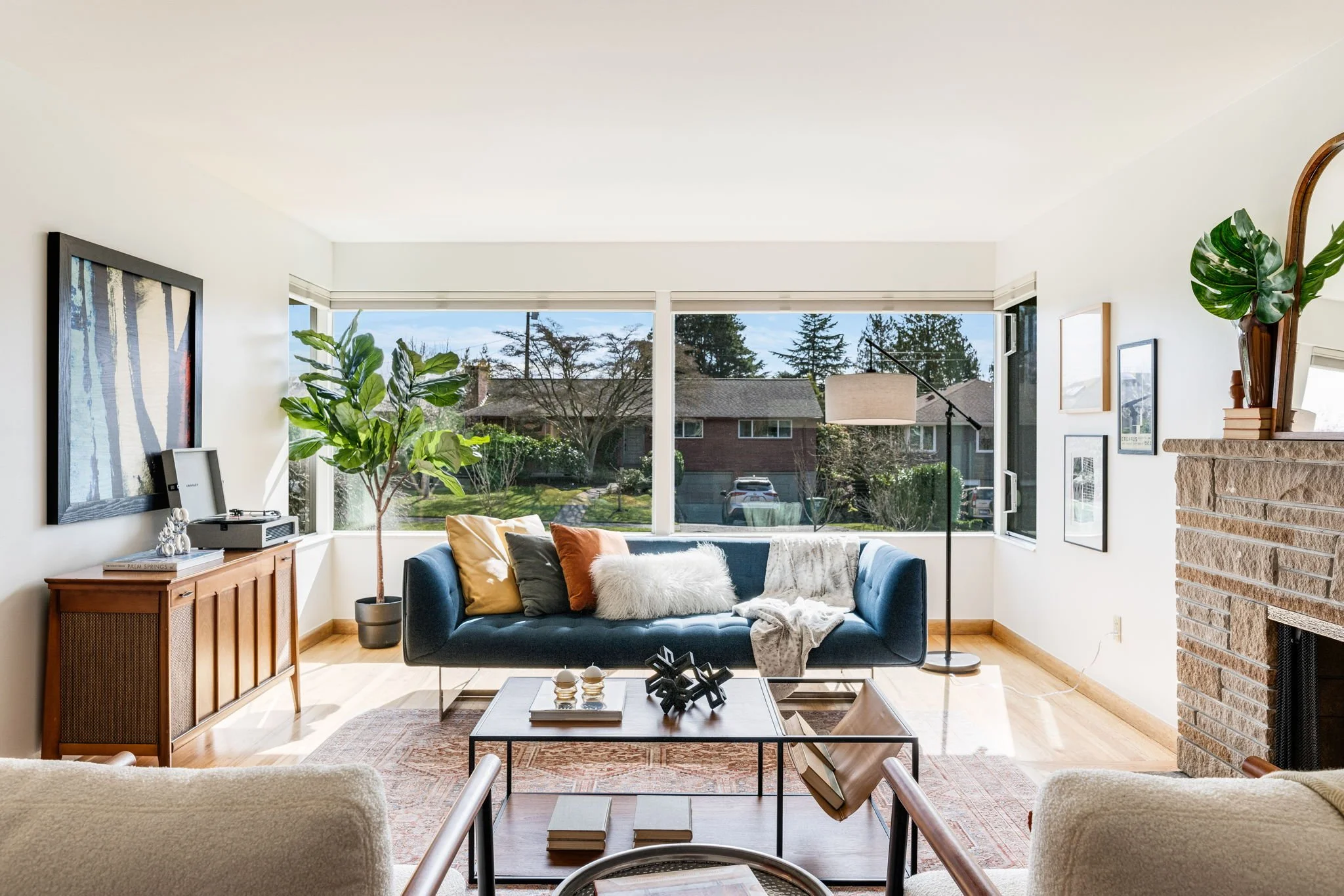 Bright living room in View Ridge with large windows, fireplace, and neighborhood views