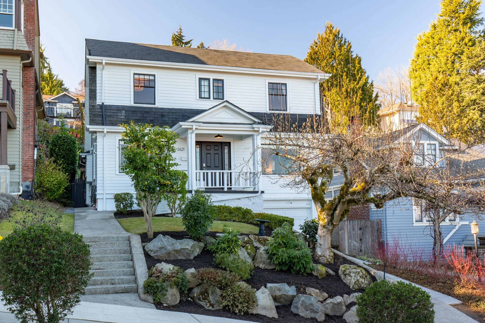 Two-story white home in Portage Bay with landscaped front yard and covered entry