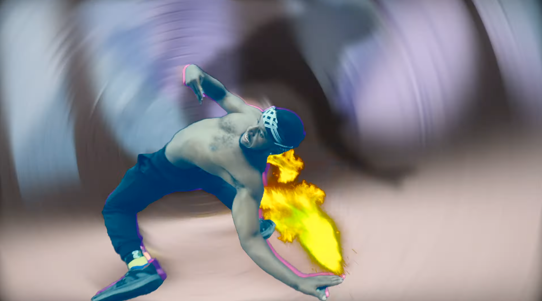 A shirtless man in a headband and athletic pants is in a dynamic pose, with flames near his hand and a blurry, swirling background.