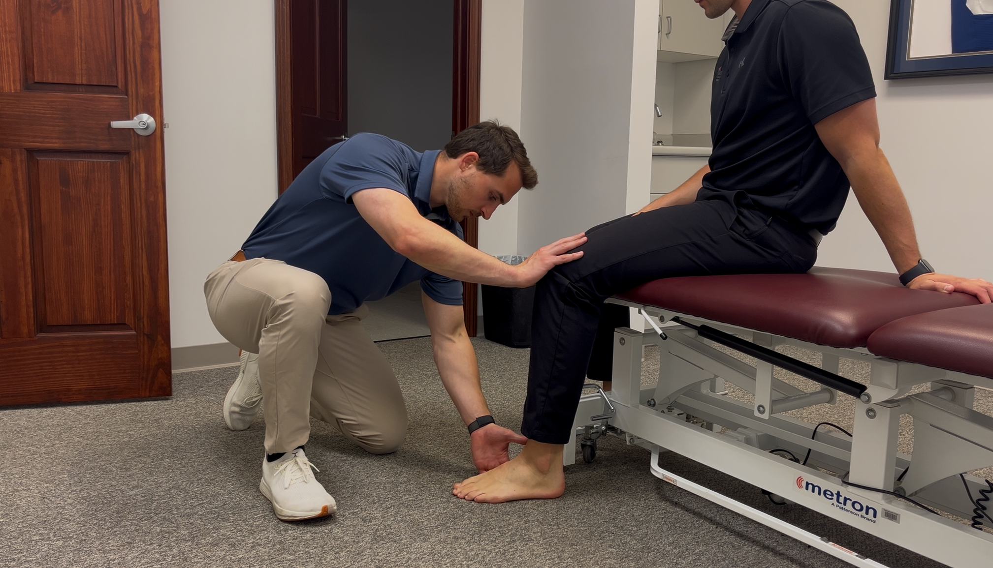 Sports chiropractor Dr. Brian Fuller performing a functional foot and ankle movement exam for plantar fasciitis at Indy Spine and Rehab.