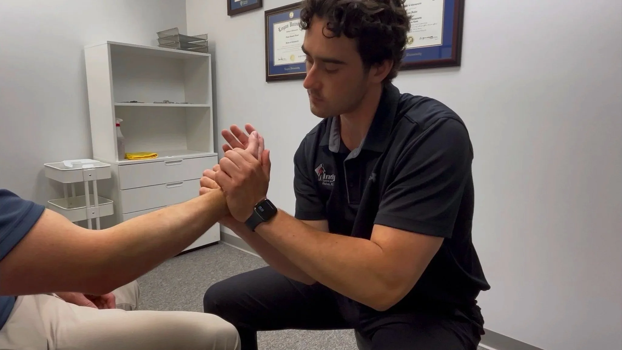 Sports chiropractor Dr. Owen Friest performing Active Release Technique (ART) on a patient's wrist for carpal tunnel nerve entrapment relief in Carmel, Indiana.