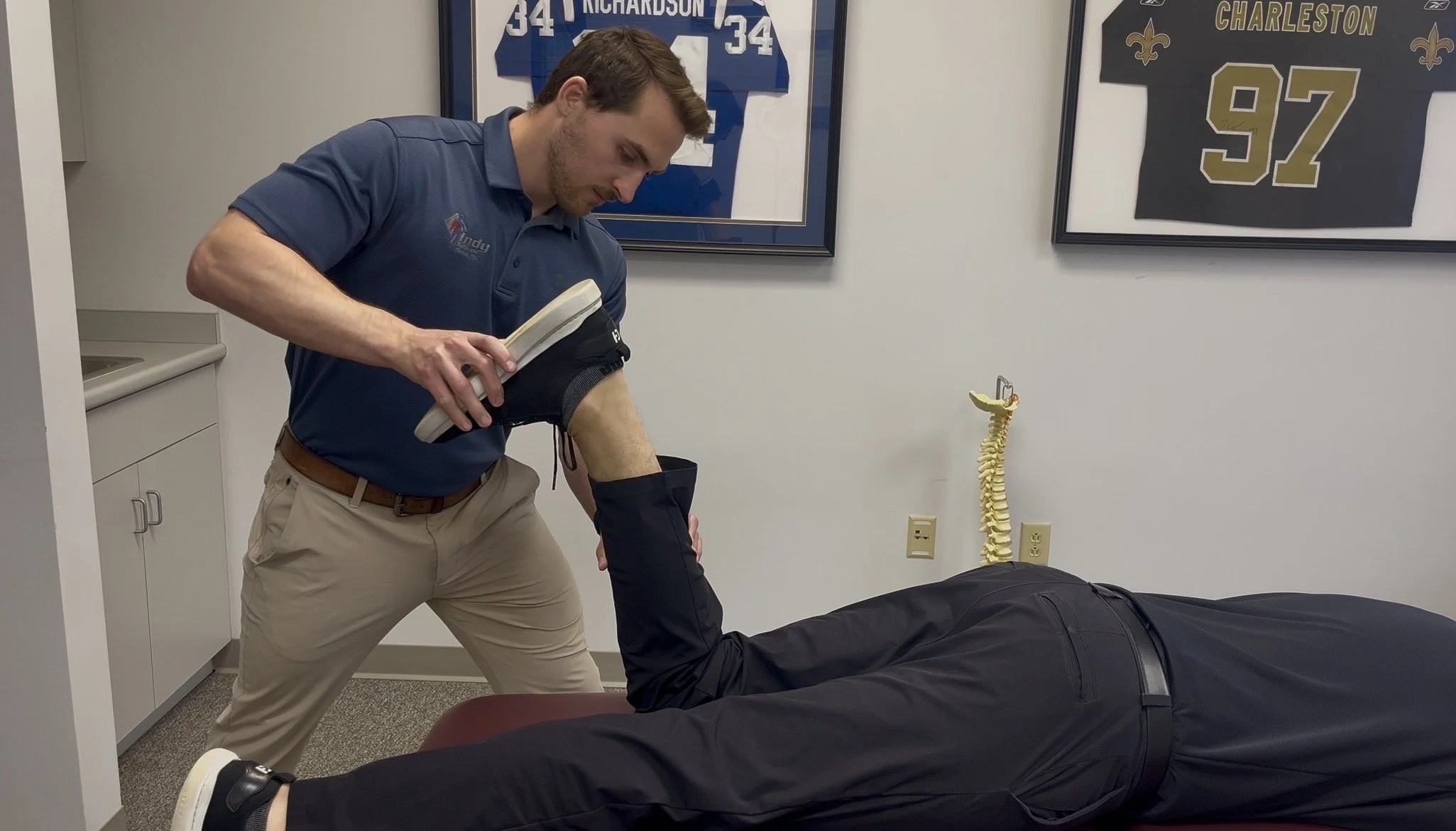 Sports chiropractor Dr. Brian Fuller providing manual movement therapy and running injury rehabilitation at Indy Spine and Rehab in Carmel, Indiana.