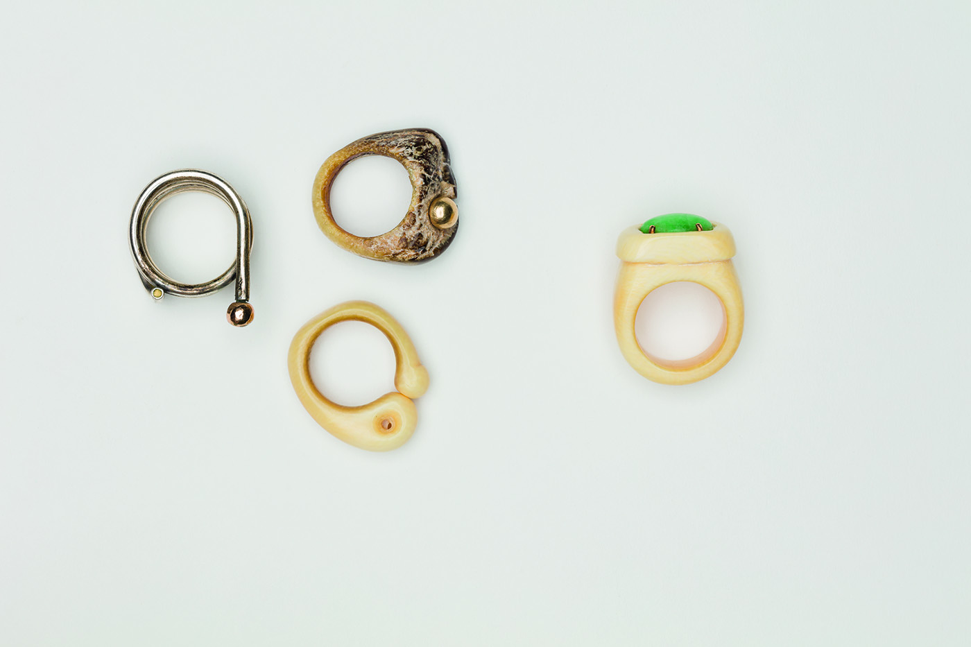  Clockwise from left:   Untitled , 1975, Silver and gold, 1 x 1 1/4 inches   Untitled , 1980, Walrus tusk, 1 x 1 inches   Untitled , 1978, Ivory, jade and gold, 1 x 1 1/4 inches   Untitled , 1978, Ivory 7/8 x 1 1/8 inches 