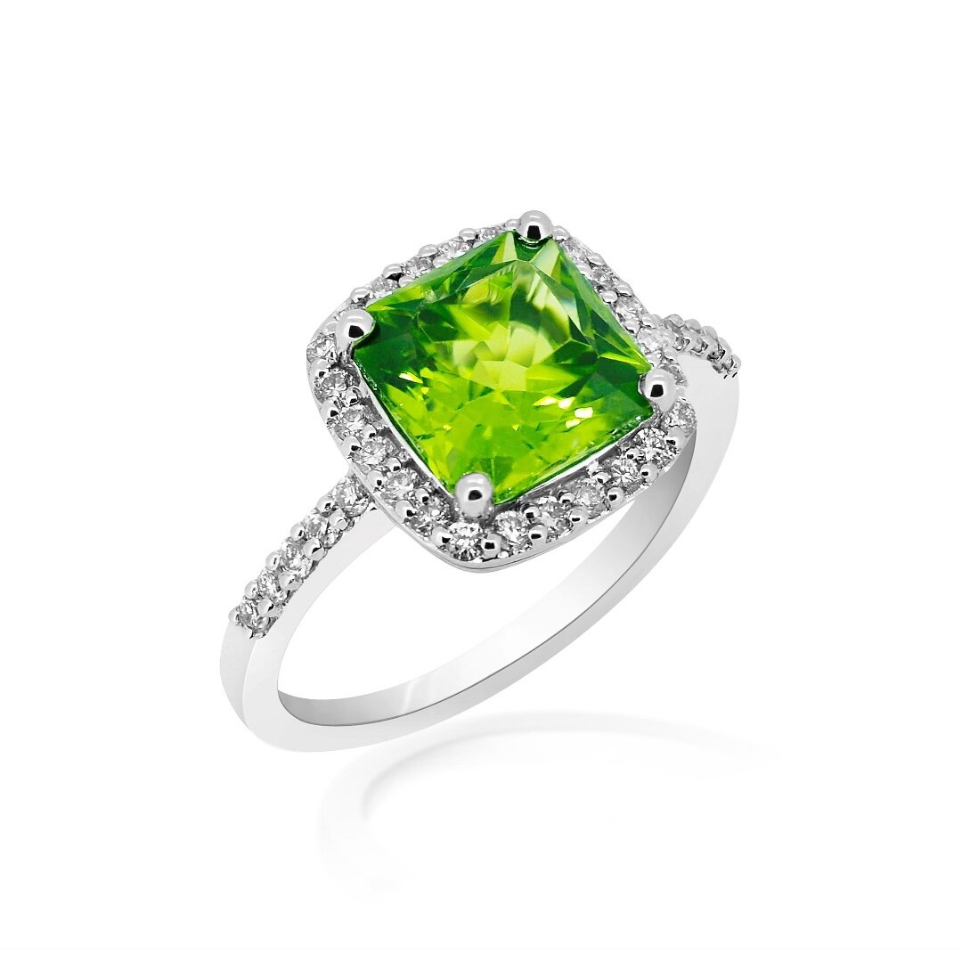 Vivid green peridot surrounded by brilliant white diamonds is sure to brighten up any outfit. As the birthstone for August, this ring would make a perfect birthday gift.