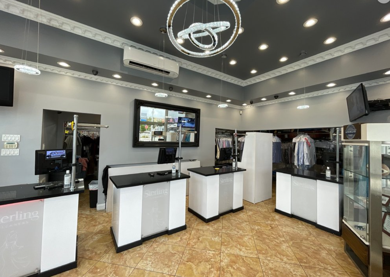 Sterling Fine Cleaning store interior with service counters and chandelier - Los Angeles dry cleaners