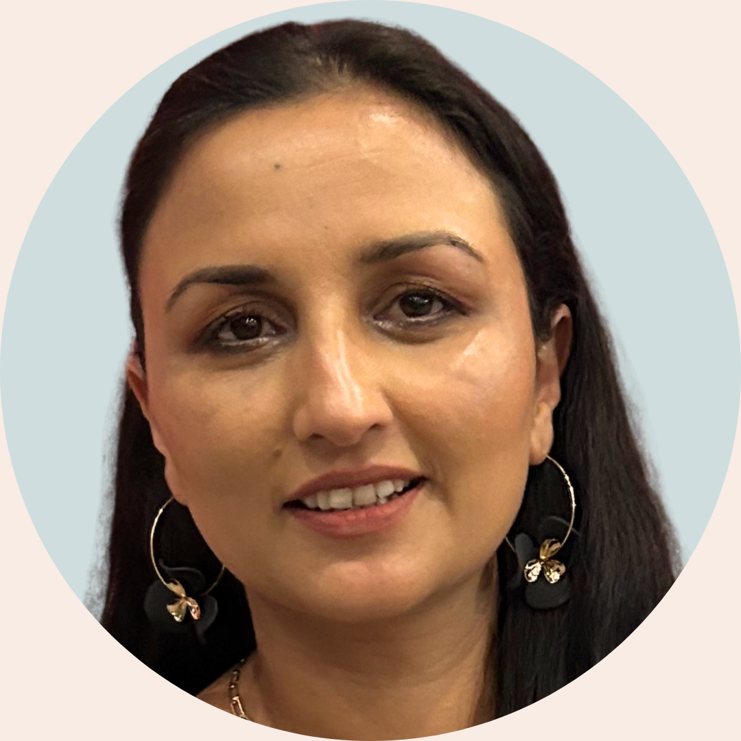 Headshot of a female health professional with dark hair, wearing hoop earrings, smiling at the camera