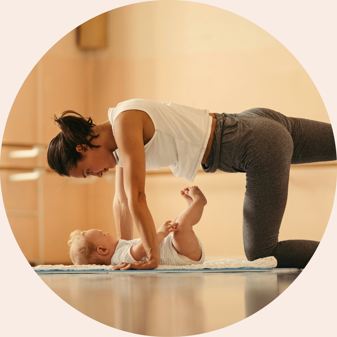 Postnatal Clinical Pilates session with a mother and non-mobile baby, focused on pelvic floor and core strength in a women’s health studio.