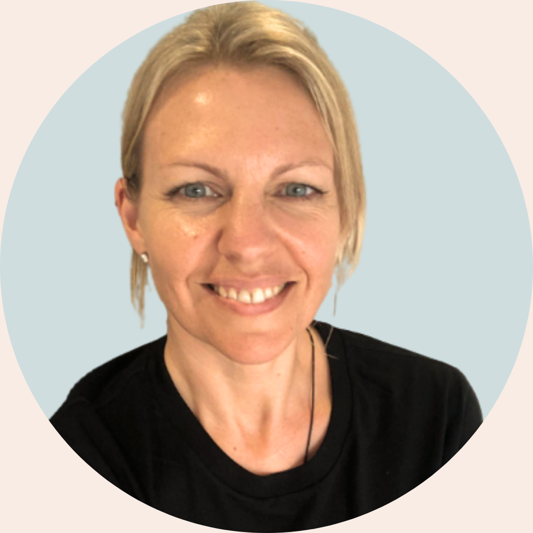 friendly, smiling therapist with blonde hair and blue eyes