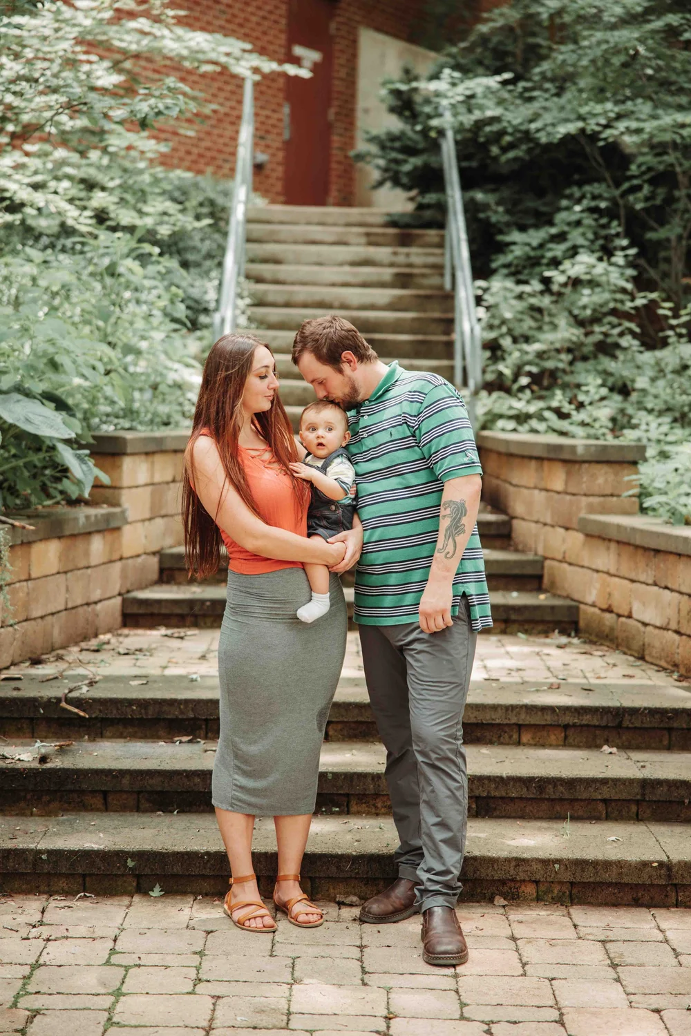 Family touching foreheads affectionately in natural golden sunlight