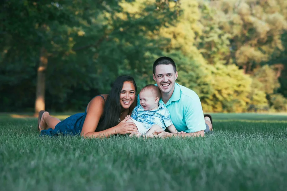 Outdoor family portrait session in park grass — Aperture Photography