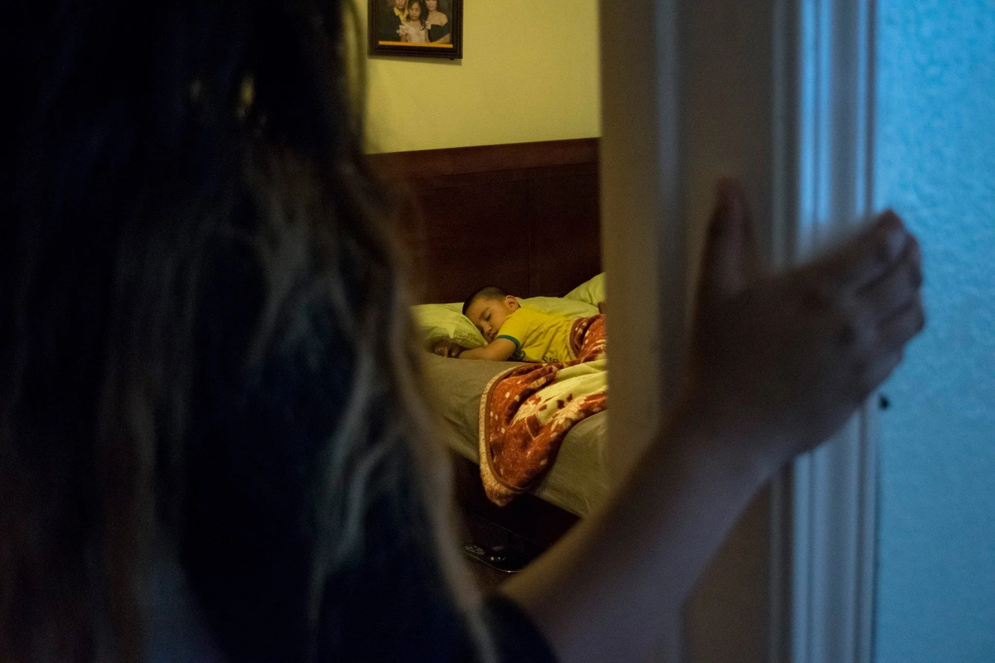Rocio Navarro takes care of her younger brother in their home in the Bayview District, San Francisco, Calif., on April 27, 2016.