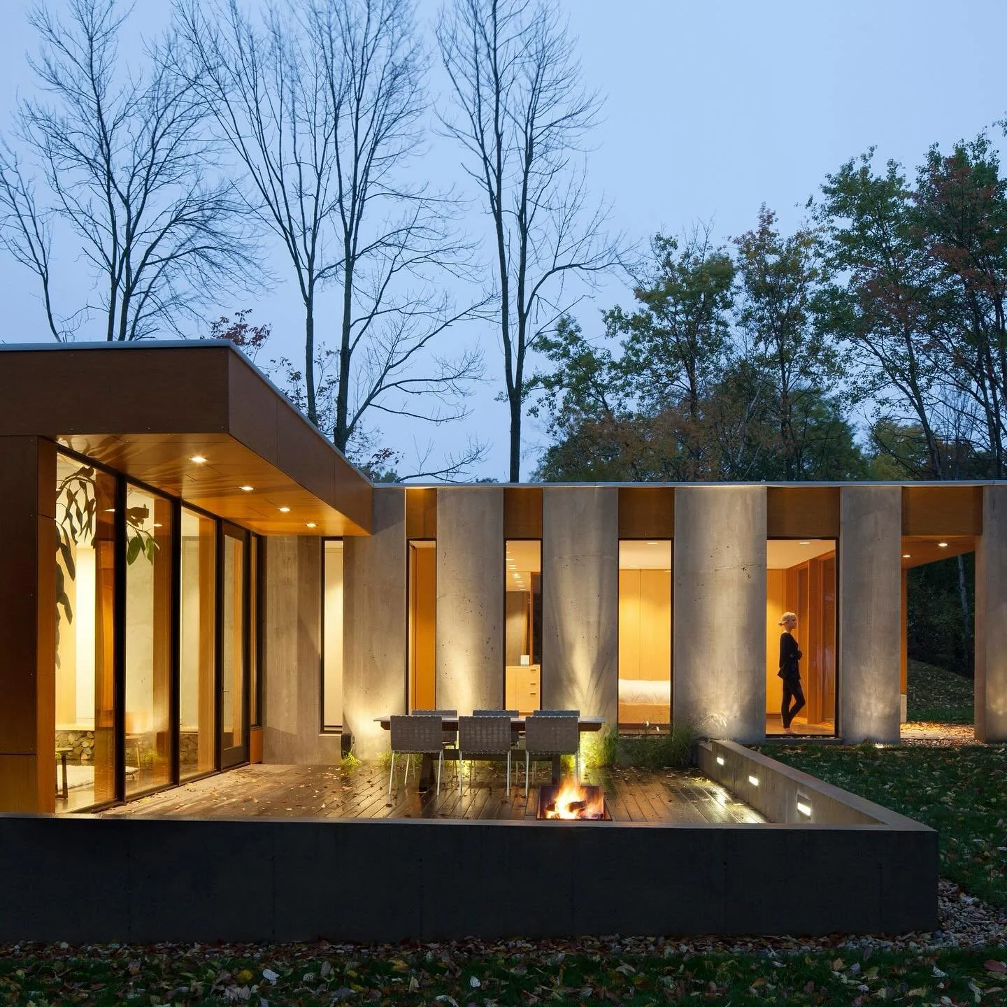 The Gradient House in Mequon, WI, integrates with its wooded bluff overlooking Lake Michigan. Its concrete and timber design features a continuous wall that divides public and private spaces, with large windows framing views of the landscape.
. 
#LDA