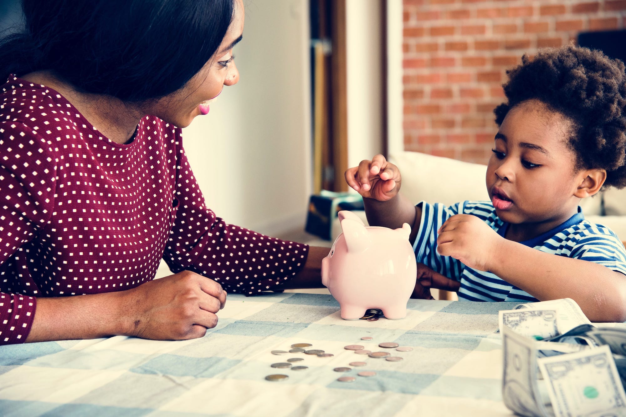 mom-and-son-saving-money-to-piggy-bank-PHFS9JX-min.jpeg