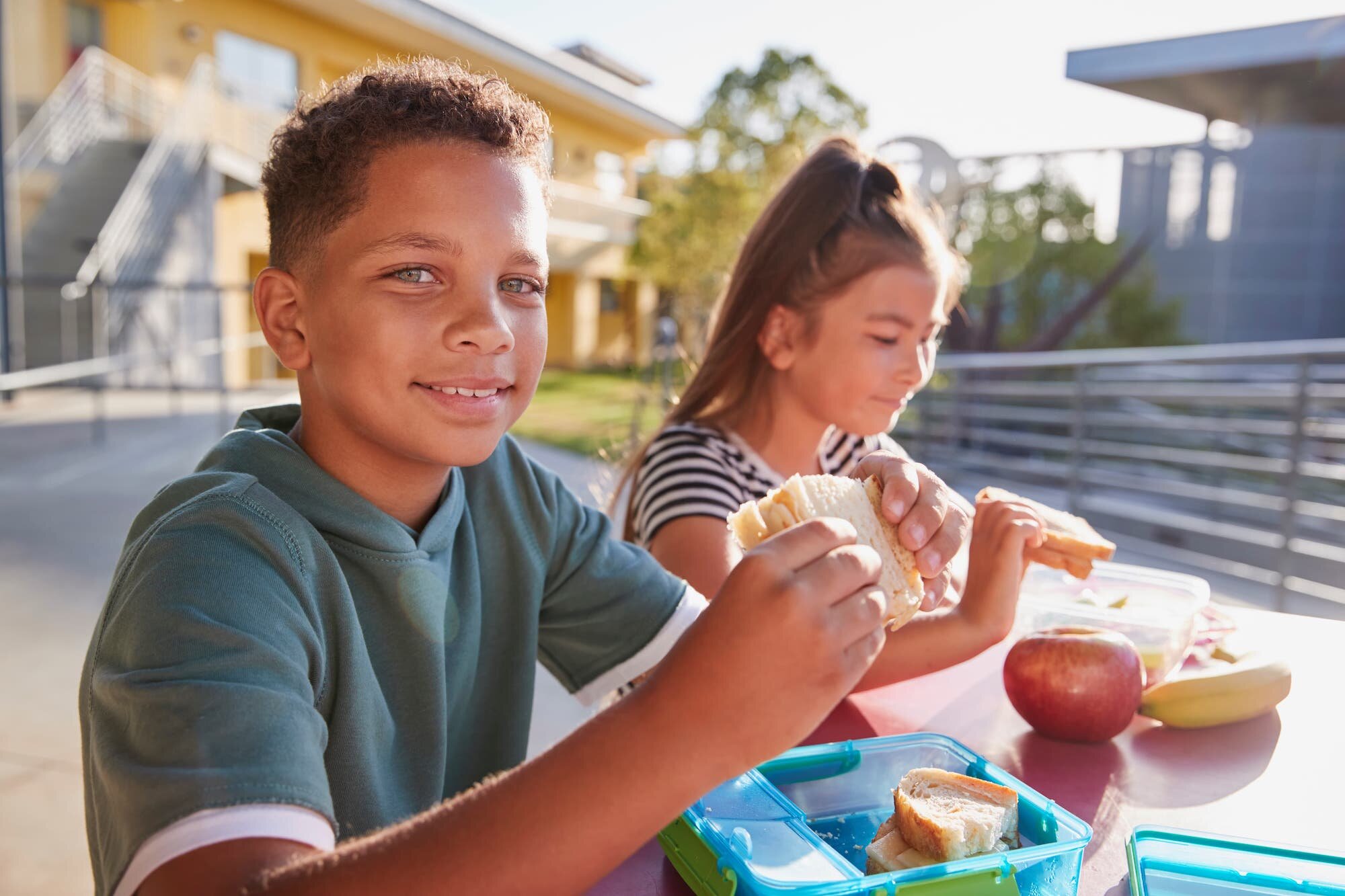boy-at-elementary-school-lunch-table-smiling-to-ME7YCVU-min.jpeg