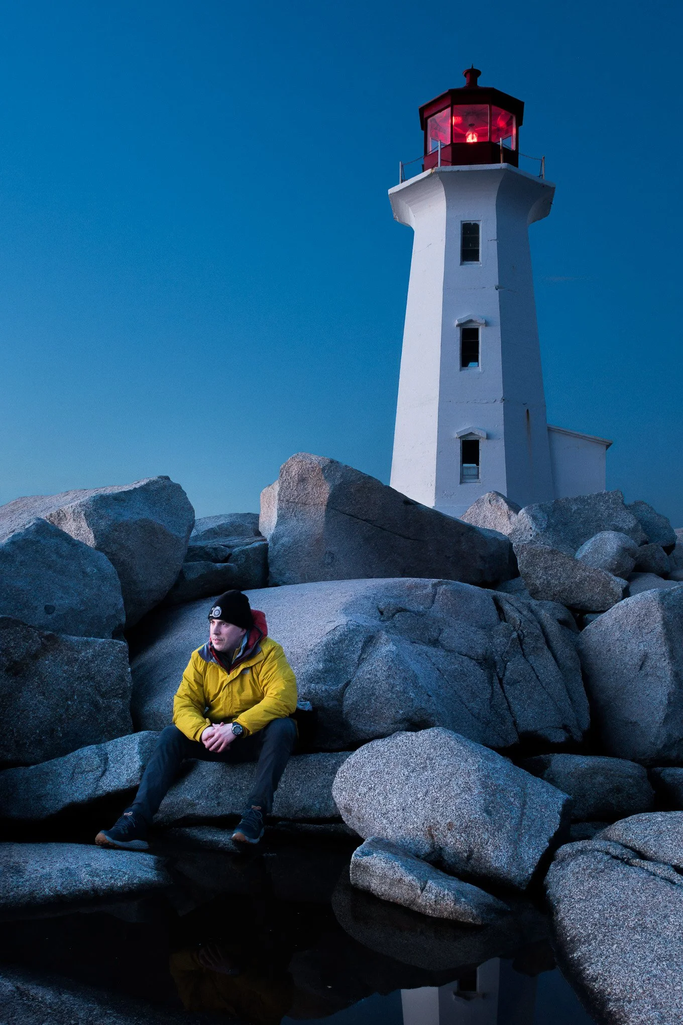 Self-portrait of artist Brendan Alex Phoenix sitting by the Peggy's Cove Lighthouse  April of 2024.
