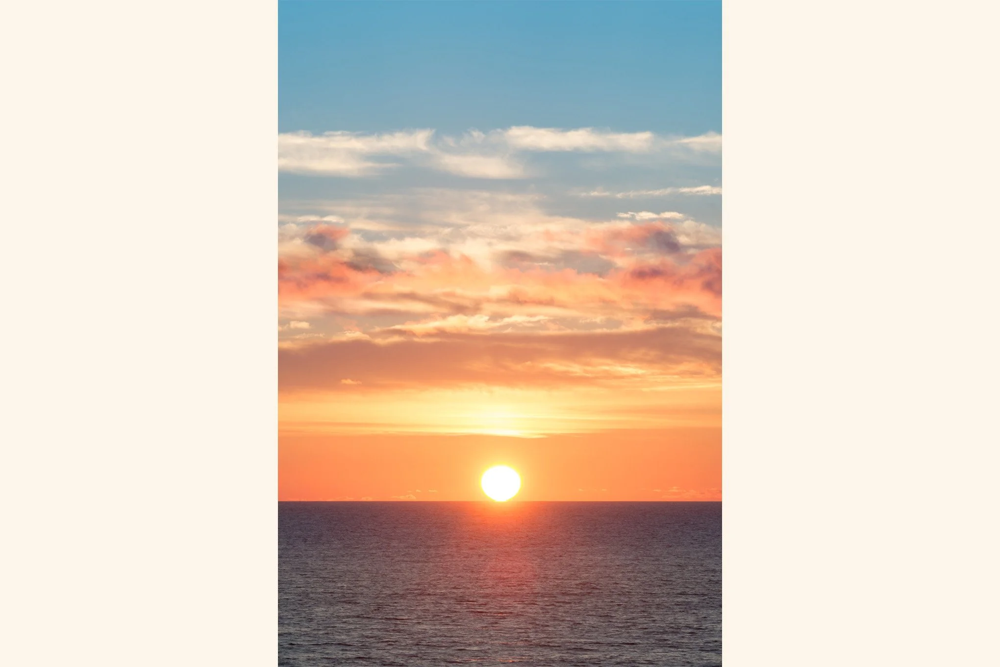 Photograph of the setting sun off the Oregon Coast by Brendan Alex Phoenix. Artwork is titled "Liquid Touch".