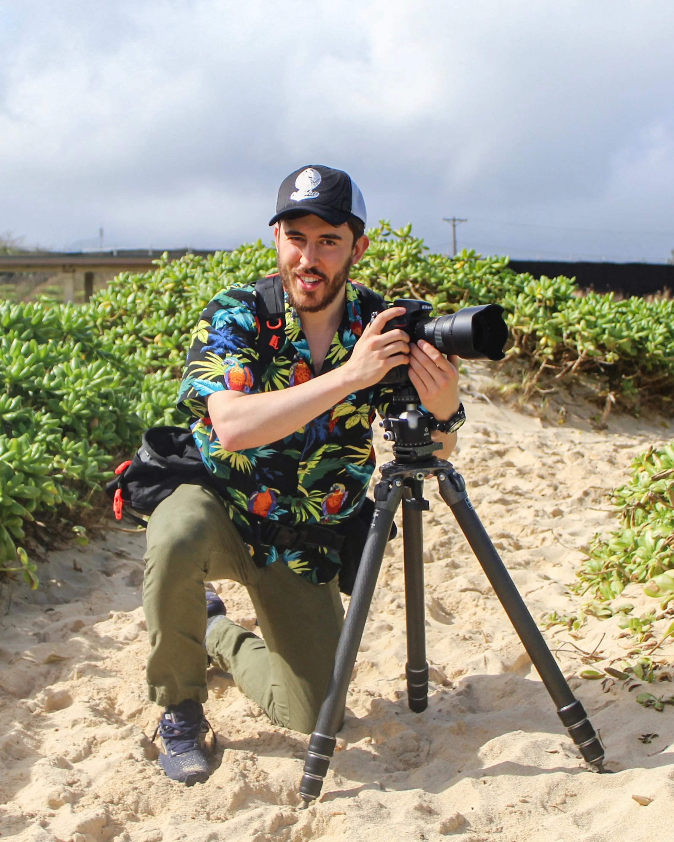 Brendan Alex Phoenix photographing at Pyramid Rock Beach on Marine Corps Base Hawaii, studying the shoreline for the right meeting of light, tide, and motion.