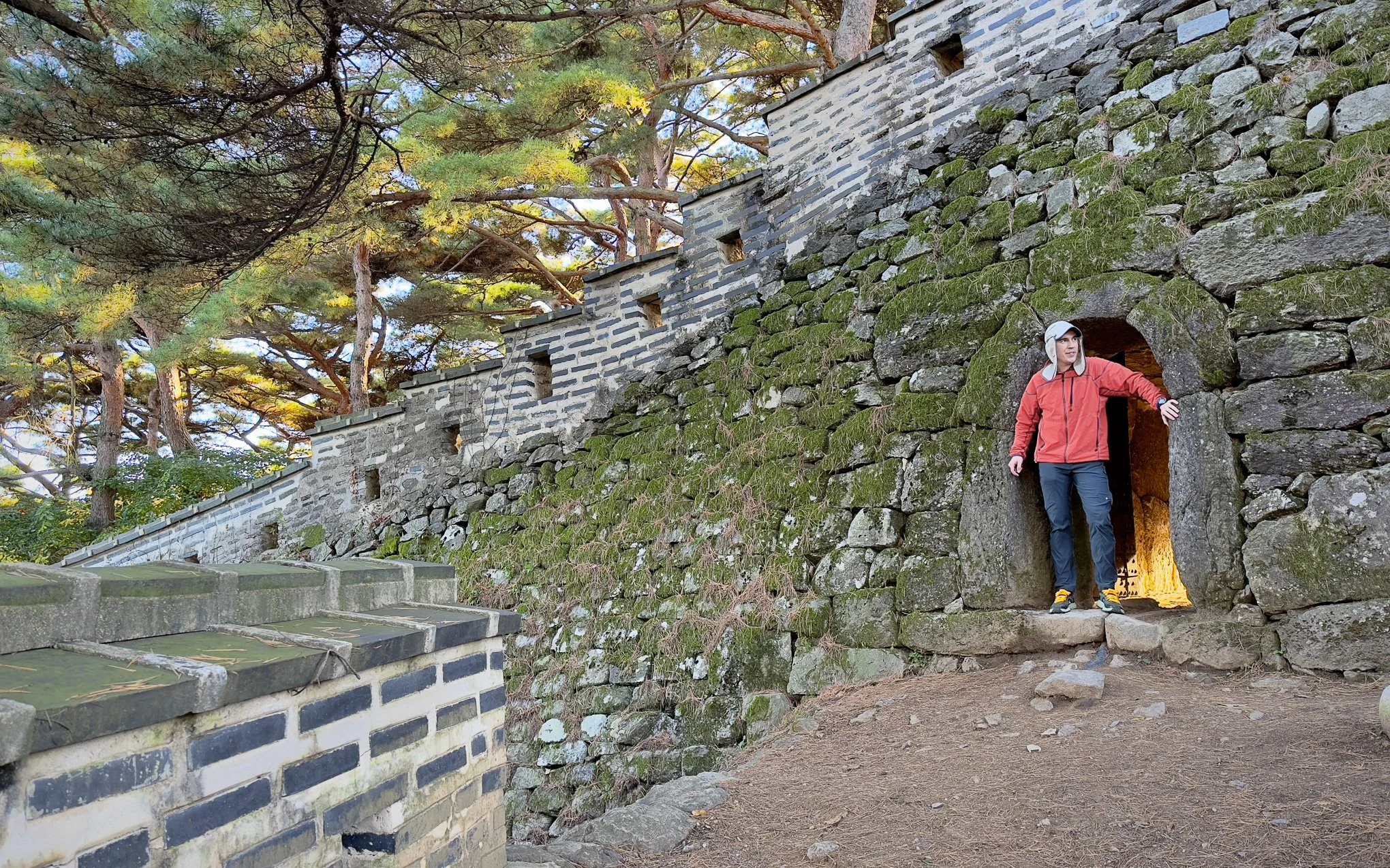 Brendan Alex Phoenix standing in the entryway to the watchtower along Namhan Mountain Fortress' west gate. October 2023