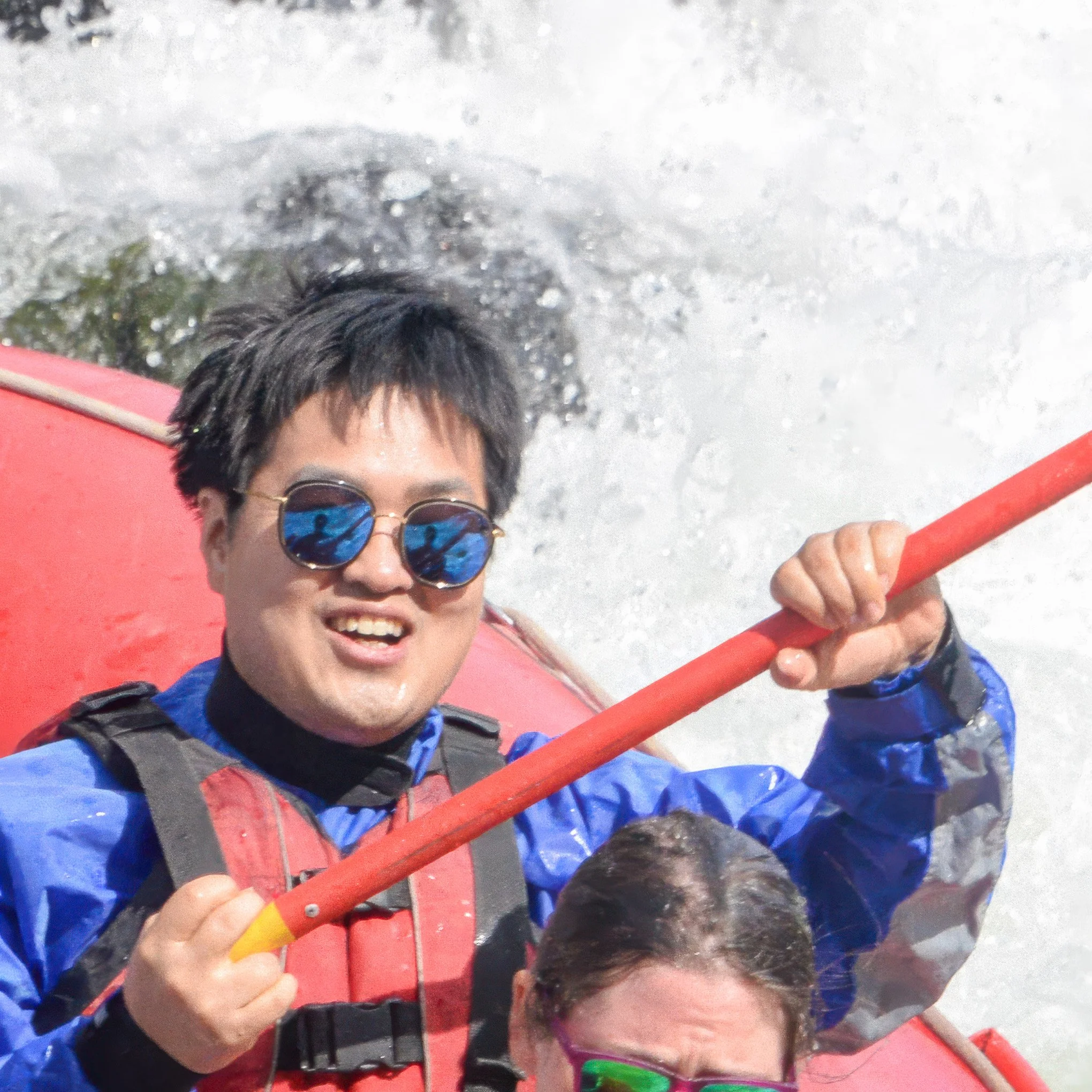 Close-up of Brendan's Korean friend rafting Big Eddy Rapid on the Deshutes River with Sun Country Tours.
