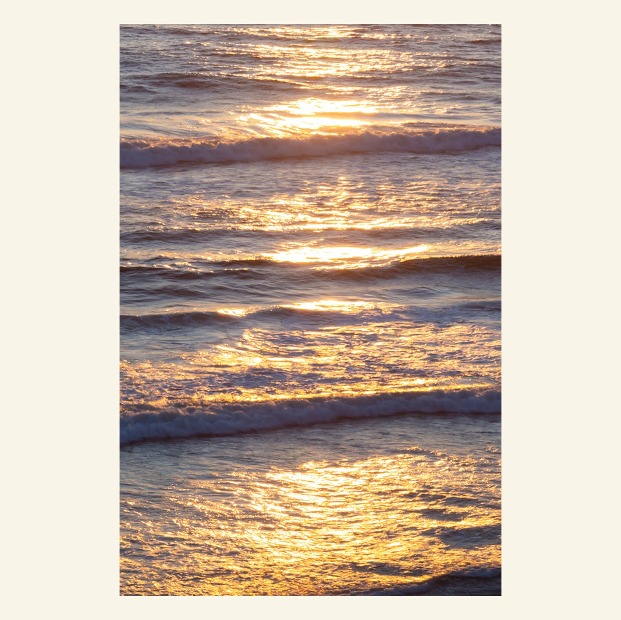 Photograph of evening sunlight reflecting off ocean waves.