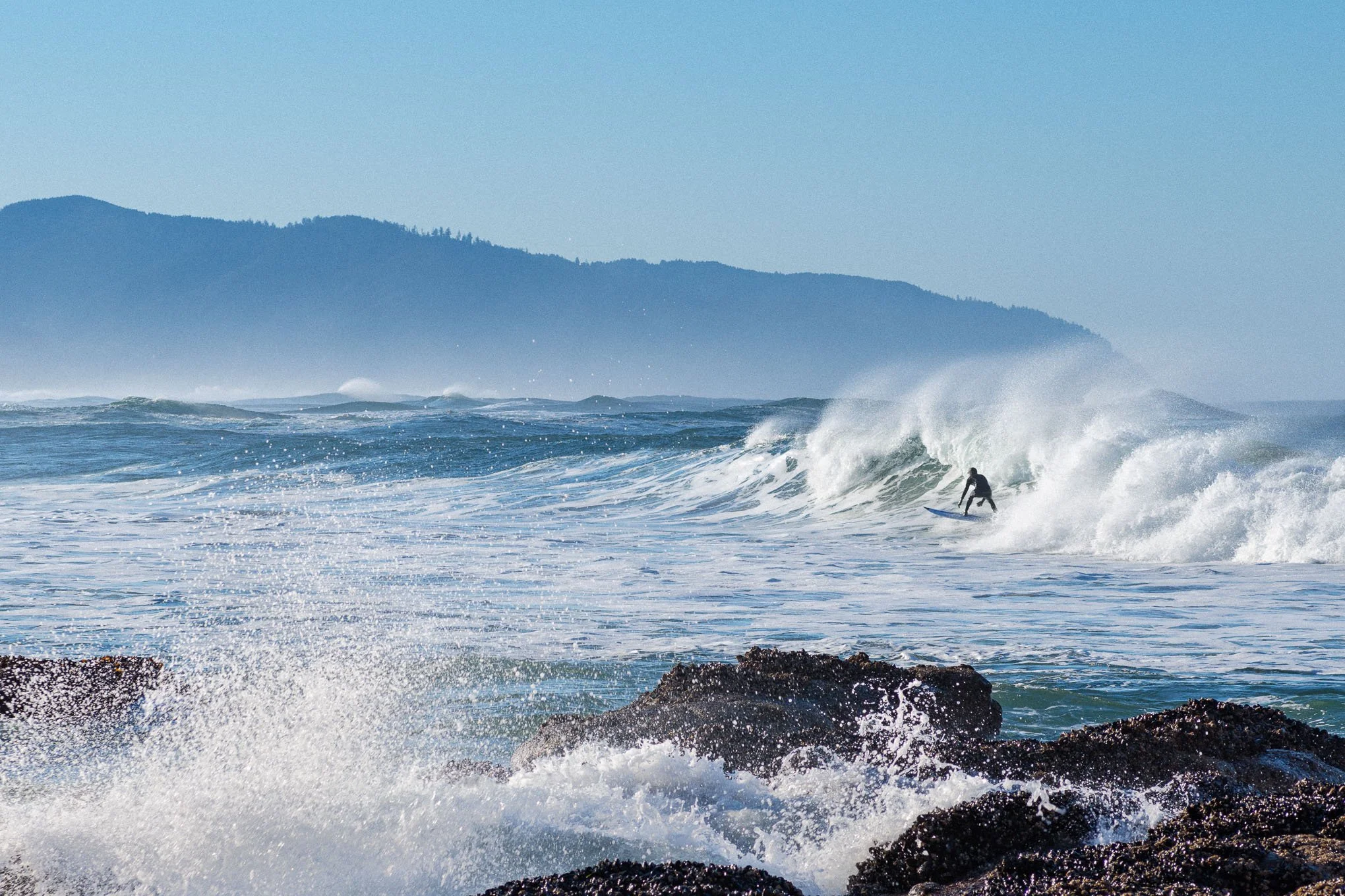 surfers-charge-surfer-riding-wave-cape-kiwanda-pacific-city-oregon-coast-winter-surfing-ocean-spray-landscape-photography-brendan-alex-phoenix.jpg