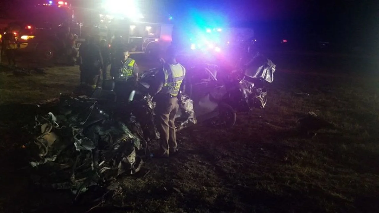 Photo by: KRIS file photo First responders inspect the Ford Fusion driven by a woman who died in a collision on Wednesday night near George West.