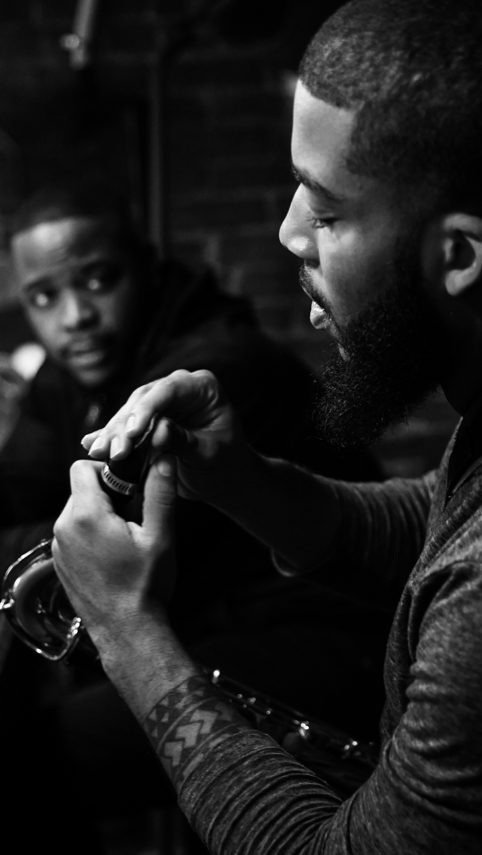Black-and-white close-up of two musicians in conversation