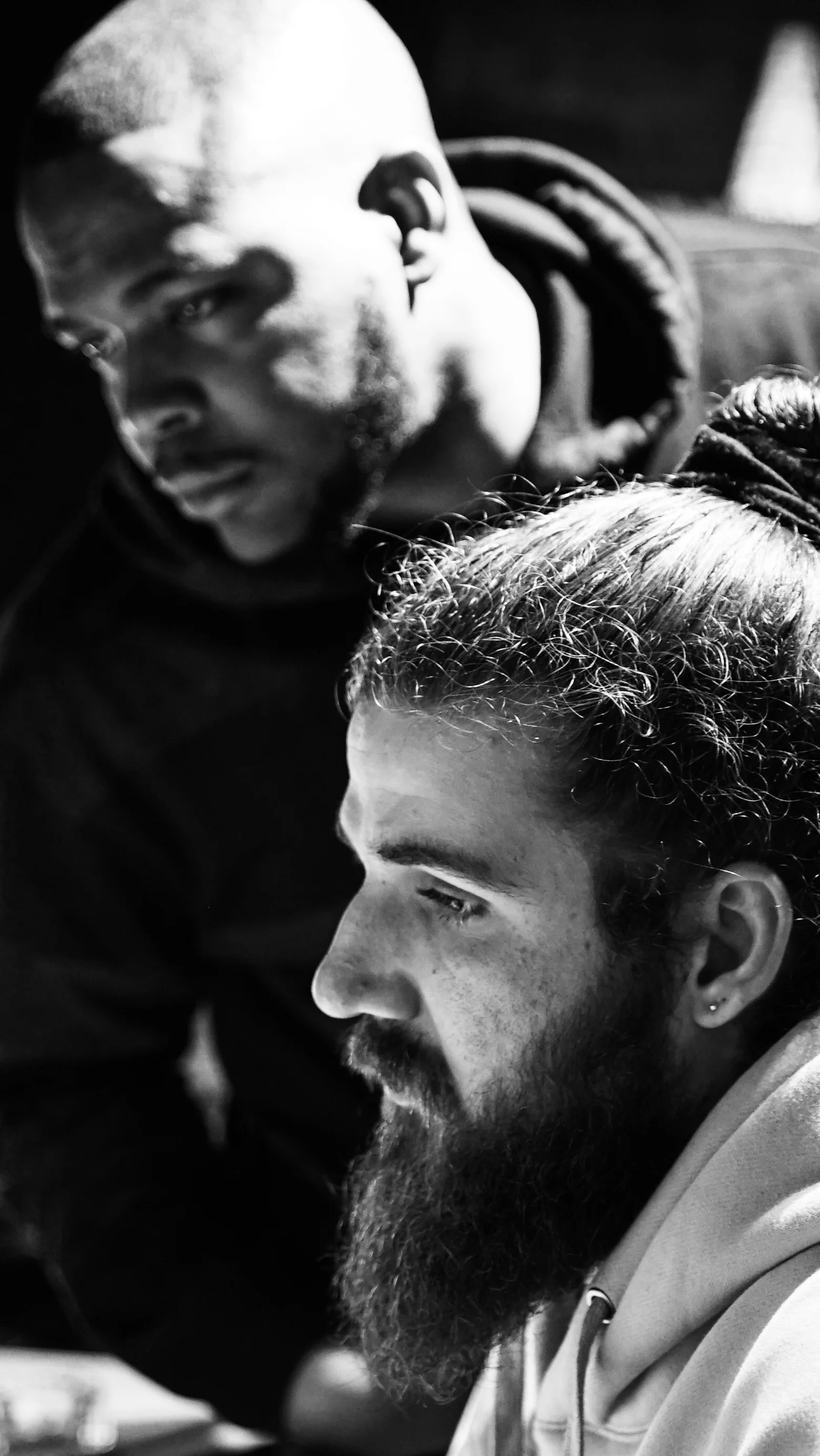 Black-and-white close-up of two musicians concentrating during a session