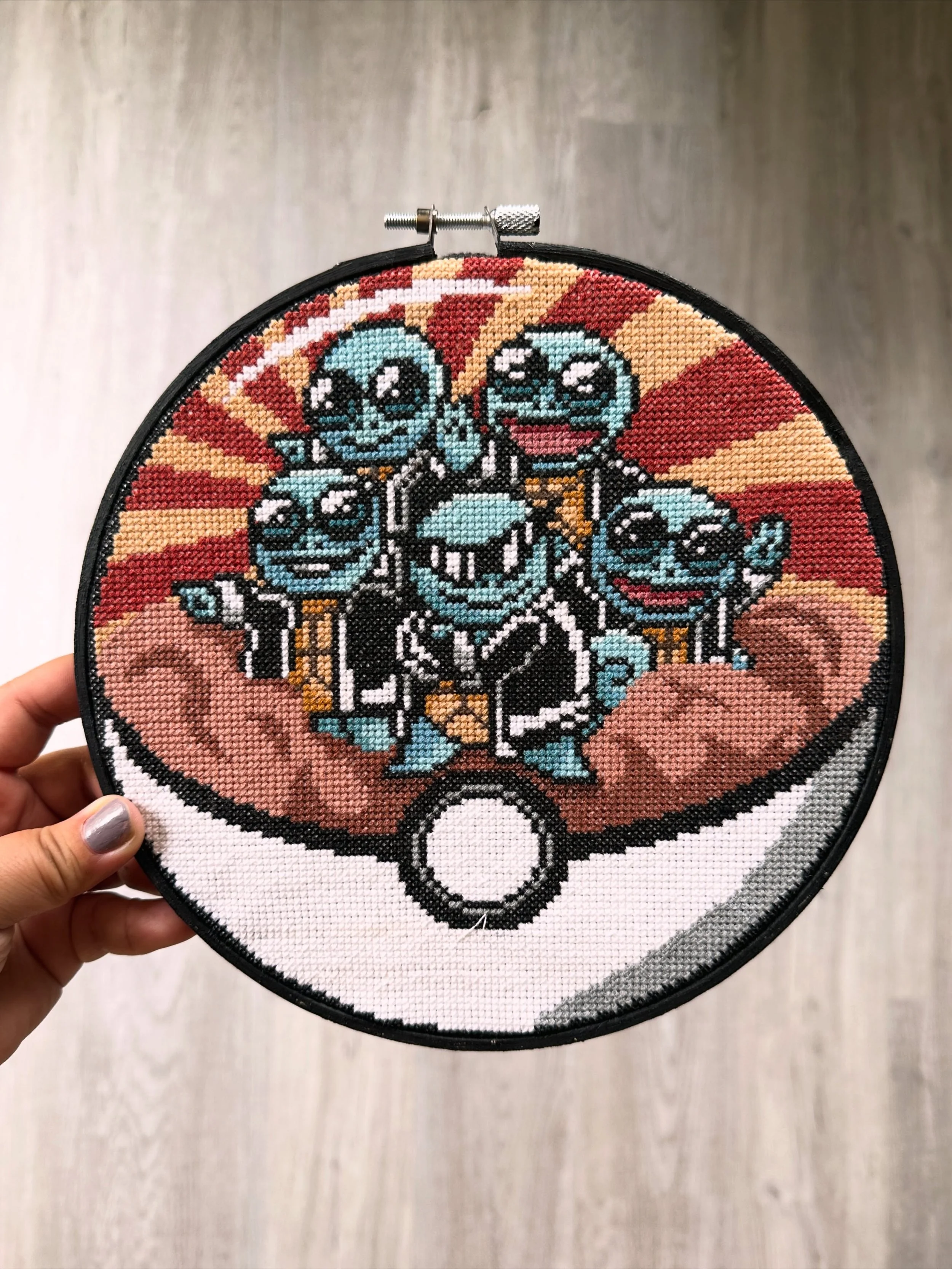 Finally, 4 months since the end of #PokemonStarterCollab2026, my Squirtle squad cross stitch is DONE. It is now proudly hung in our very own Pok&eacute;mon museum in our basement. I painted the embroidery hoop black to blend in with the black crossed