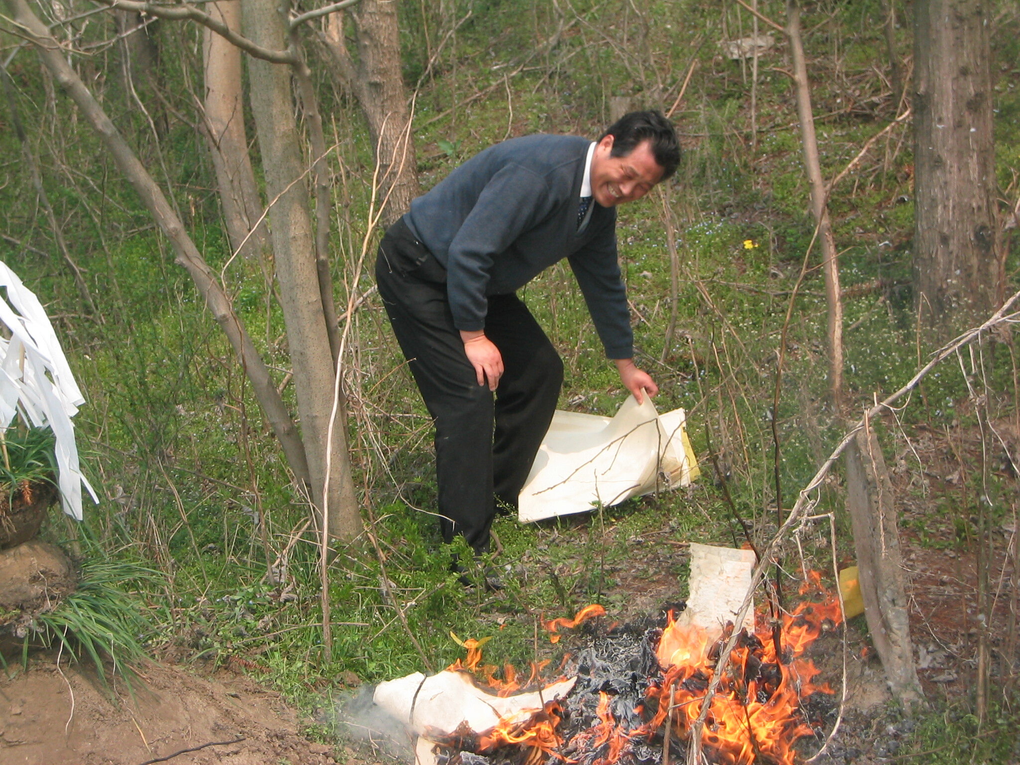  “Book Idiot” Zhou burns paper money for his deceased parents in 2003. 