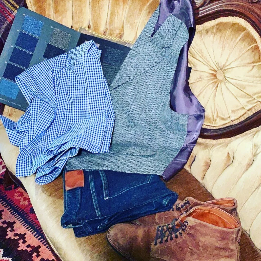 Tailored clothing, knitwear and accessories arranged for travel.