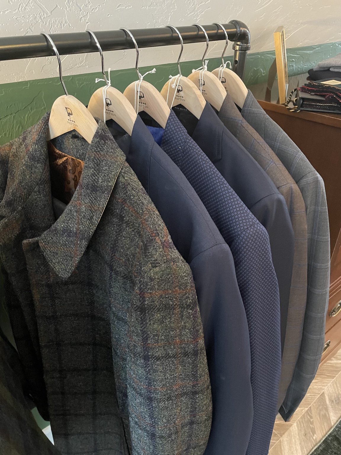 PATTON clothing staged for fitting and delivery.