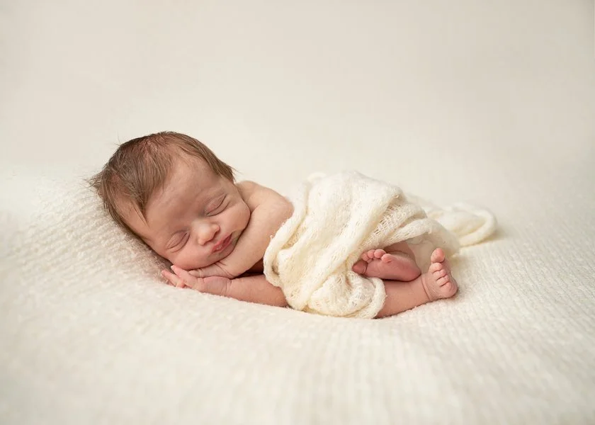 Melbourne newborn photographer image of sleeping newborn baby on her side with neutral tones
