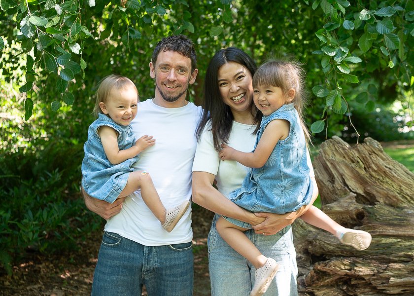 happy family photo of mum, dad and two girls outdoors