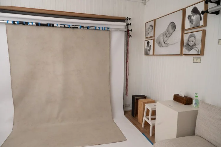 Image of the interior at Susan Bradfield Photography's Bayside Brighton studio. The image shows a neutral backdrop and wall art of newborn photography