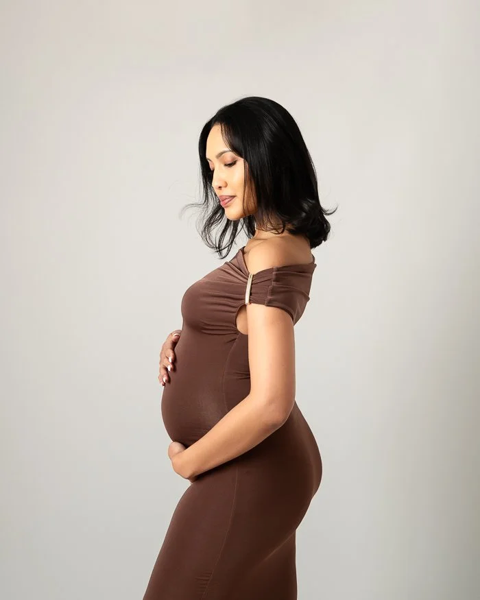 Melbourne photographer Studio photo of pregnant woman side on wearing a black dress