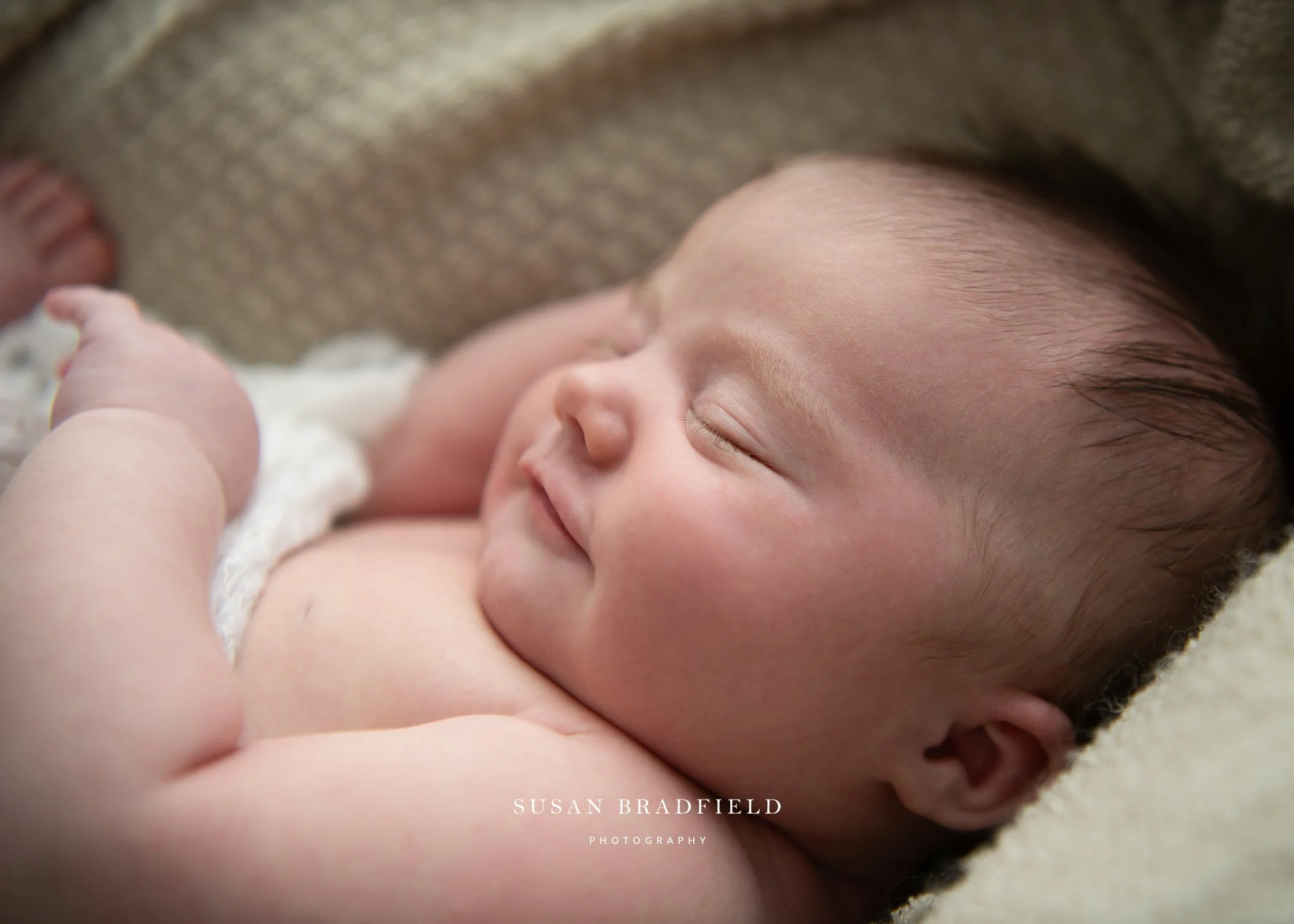 Susan Bradfield Photography image of a close up of a sleeping baby from the side.