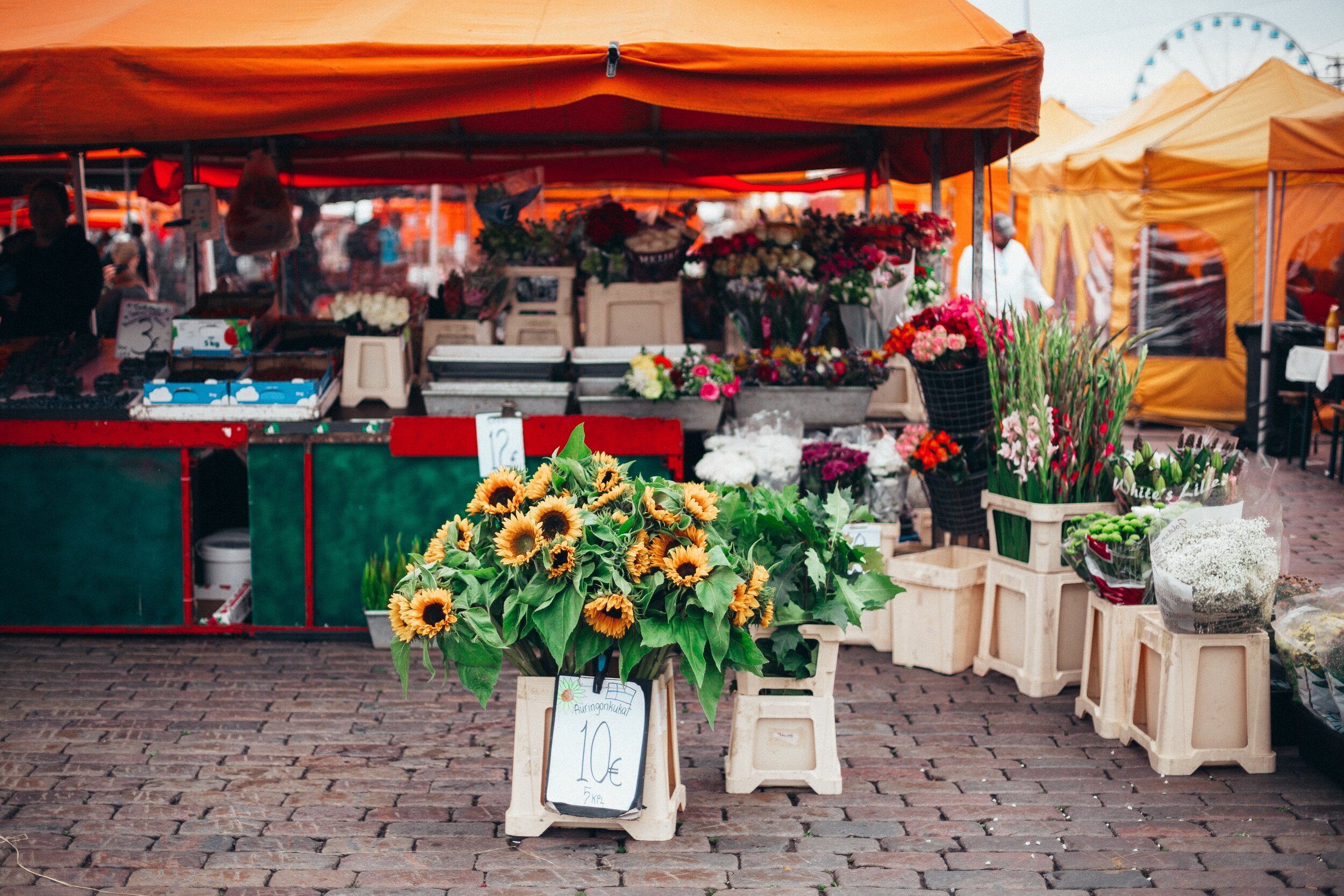 sunflowers-on-rack-with-price-tag-near-orange-canopy-tent-1508746.jpg