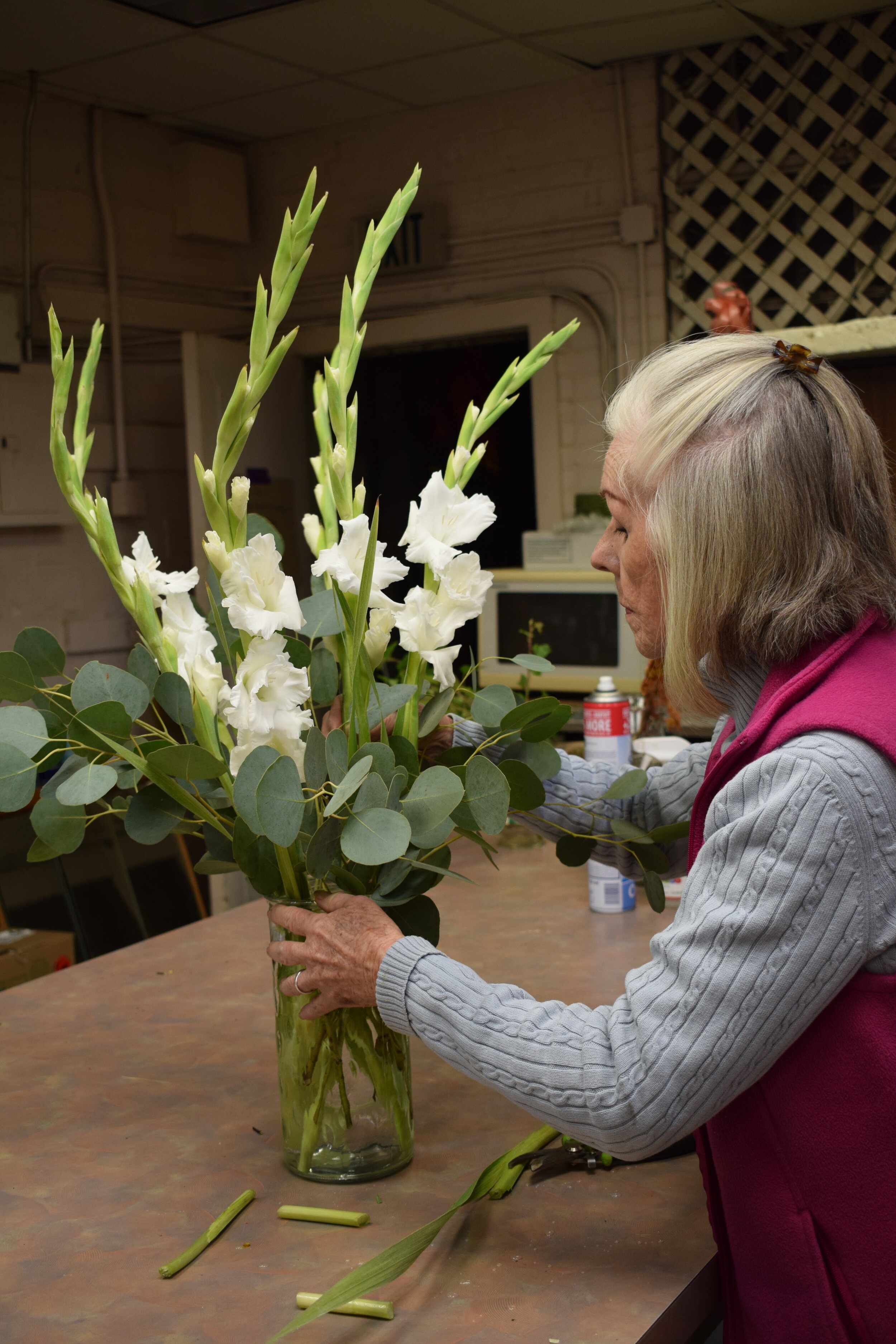 Rosemary working on custom floral arrangement.JPG
