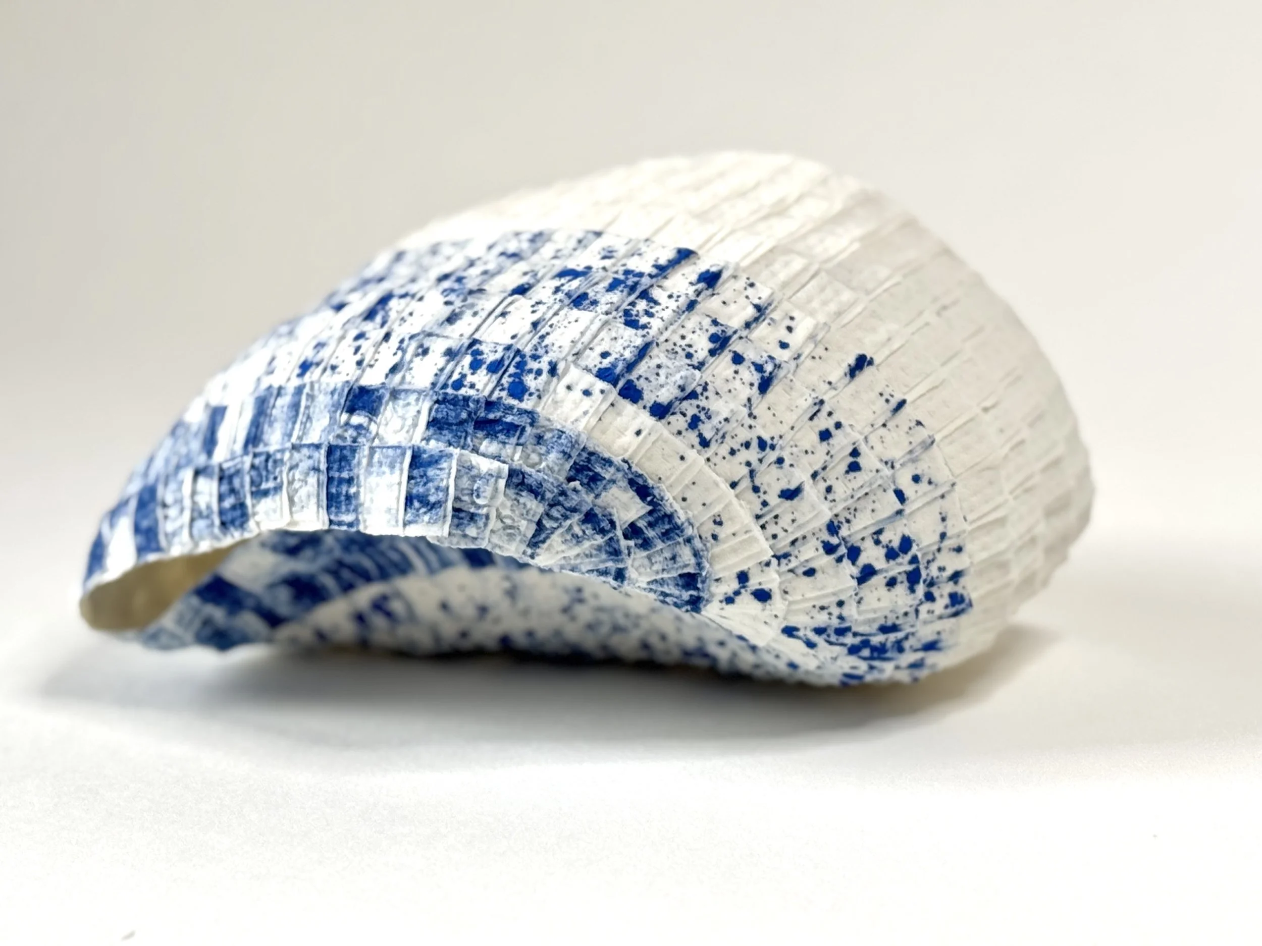 Paper porcelain sculpture with Porcelain de Limoges, colored with blue stains.