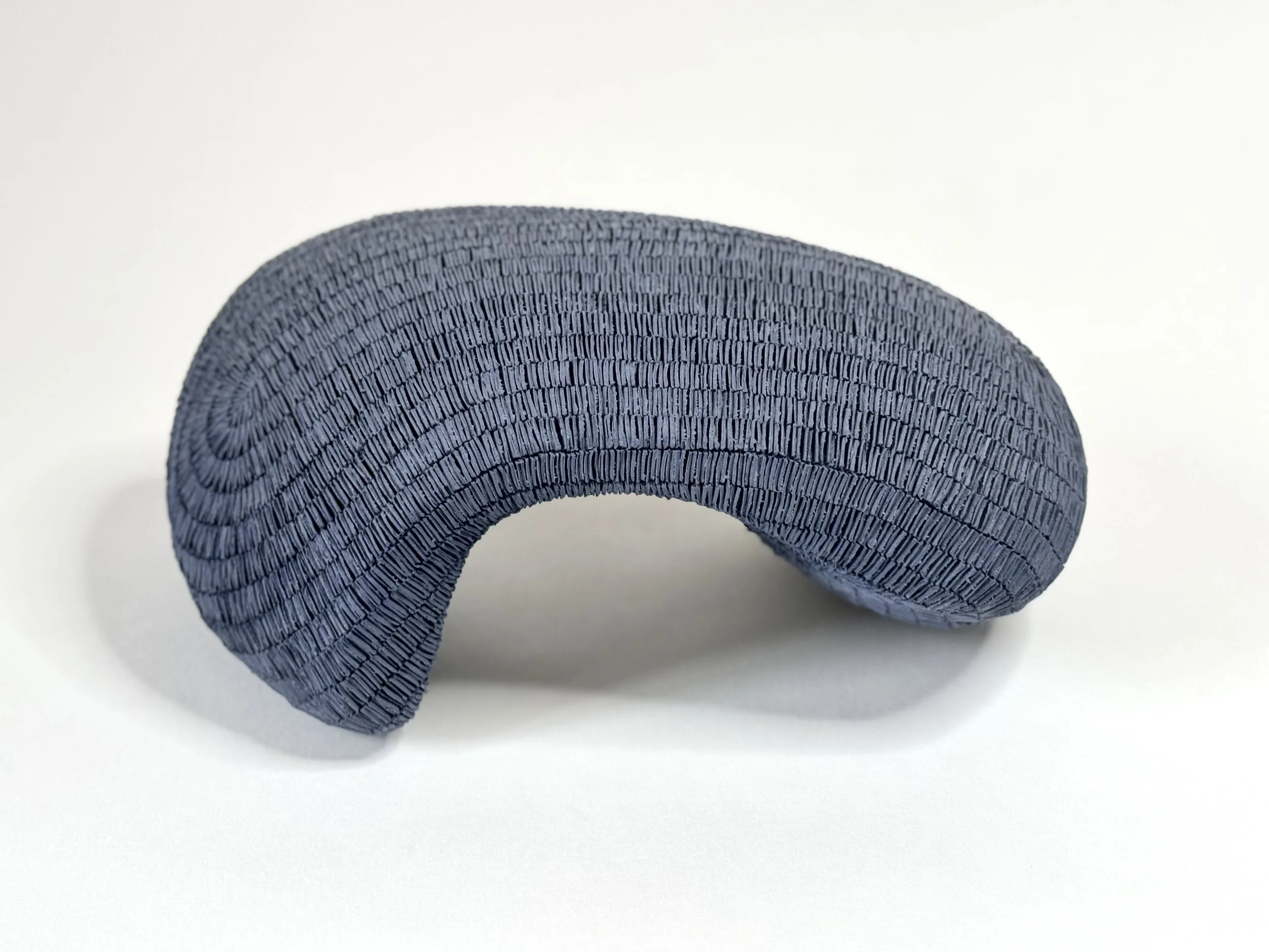 Paper porcelain sculpture colored with dark blue stains