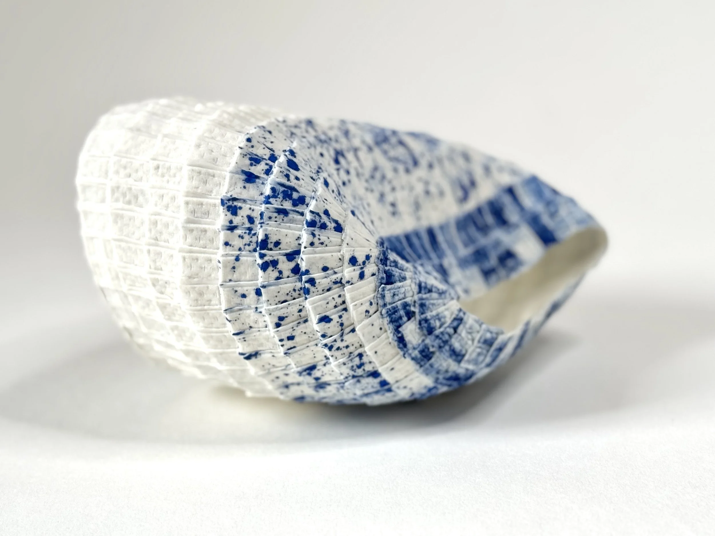 Paper porcelain sculpture with Porcelain de Limoges, colored with blue stains.