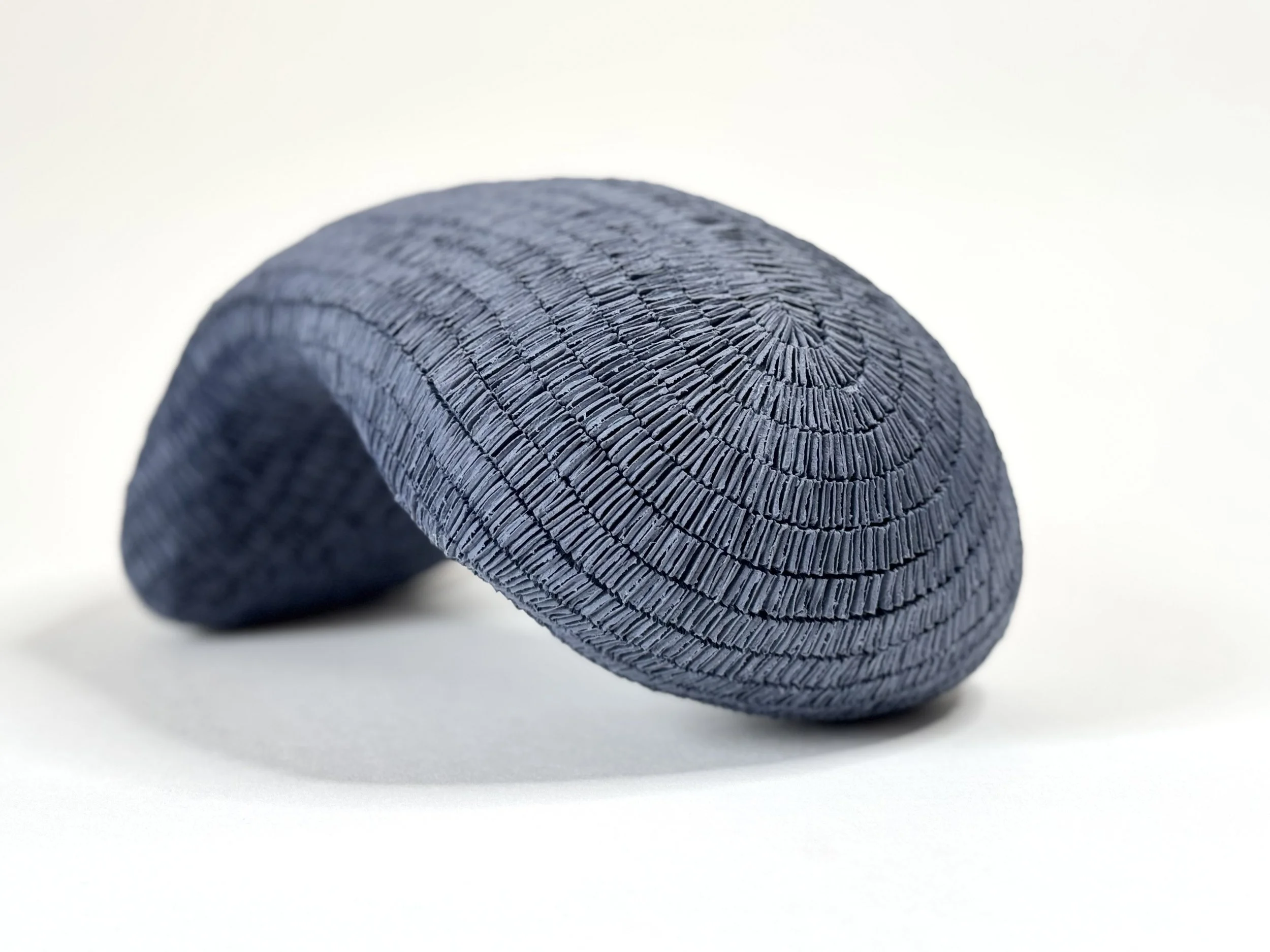 Paper porcelain sculpture colored with dark blue stains