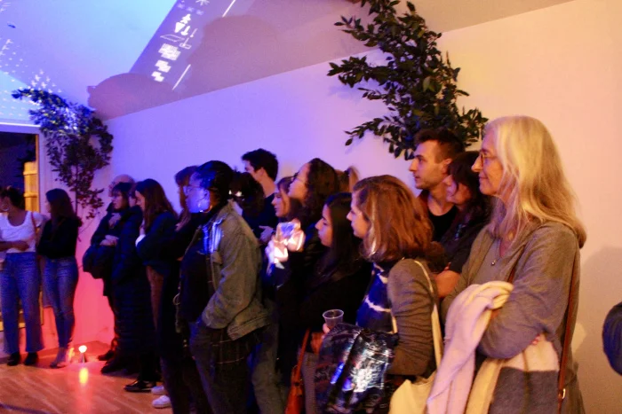  Rapt audience members watching Hamlet and Ghost on the battlements with projections by jjjbon and Max-Louis 