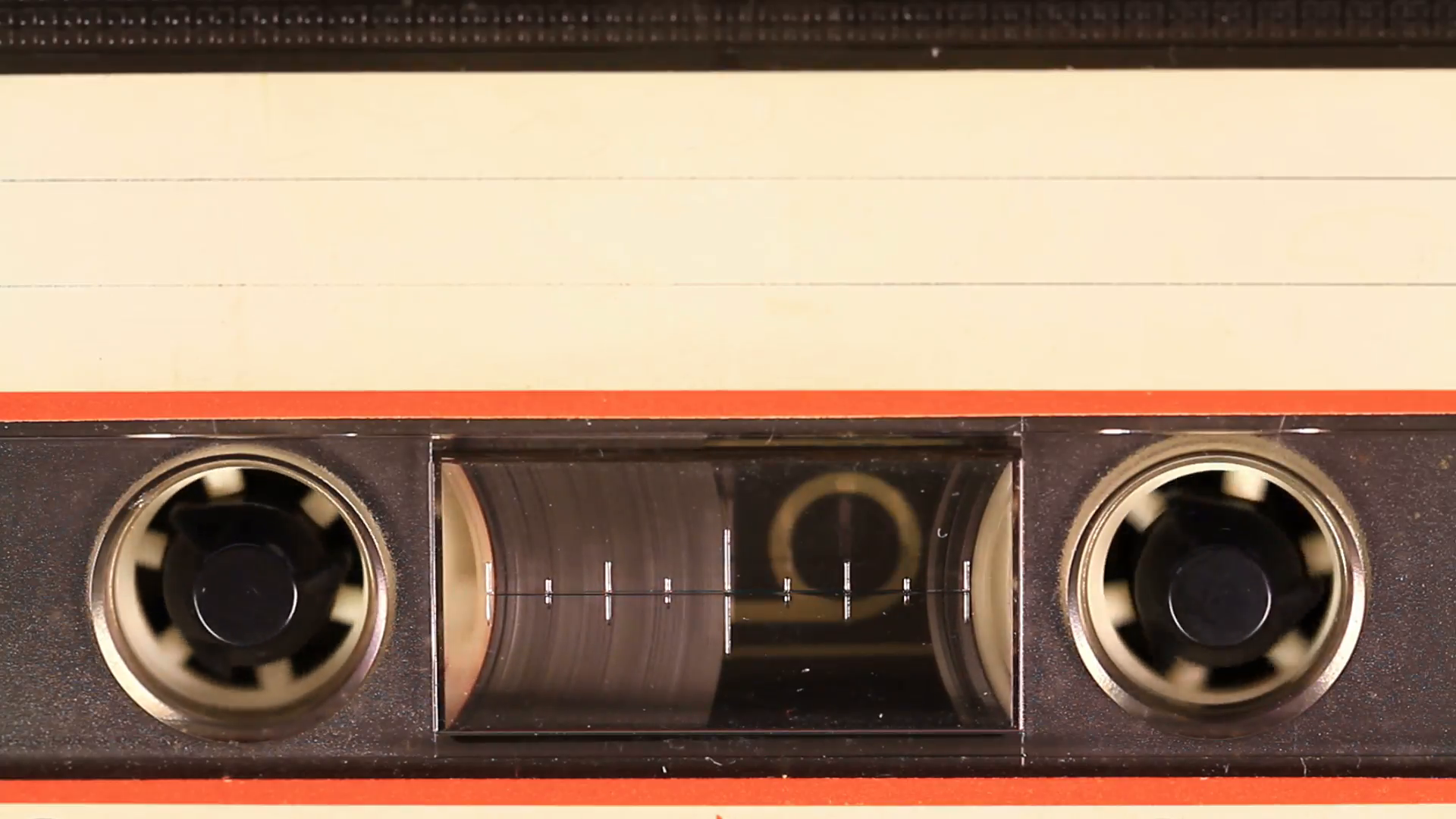 macro-static-camera-view-of-vintage-audio-cassette-tape-with-a-blank-white-label-in-use-sound-recording-in-a-cassette-player-cassette-tape-with-a-white-blank-label_n1mgvao6__F0000.png