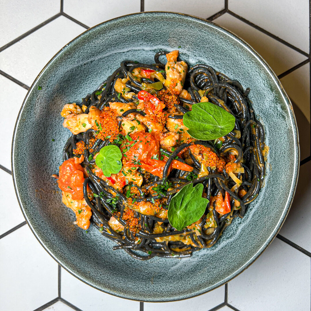 Lunch time at Urban Artisans! Squid ink spaghetti with blue swimmer crab, braised leek, blistered cherry tomatoes &amp; spicy tomato butter.