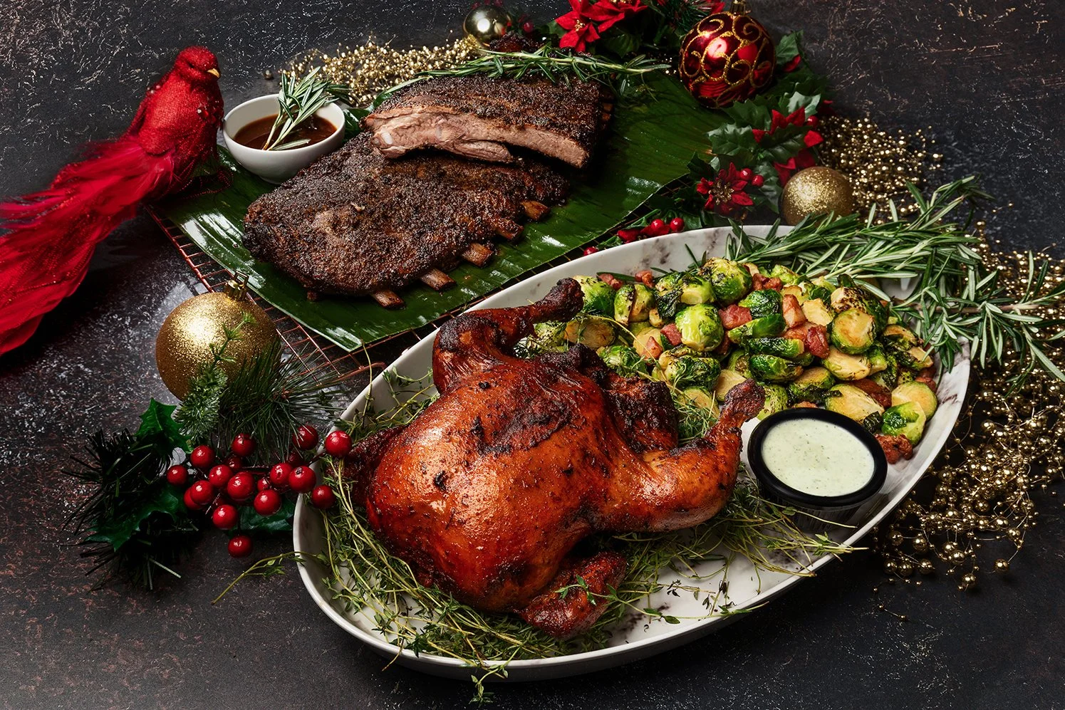 Holiday feast with roasted chicken, Brussels sprouts, and ribs.