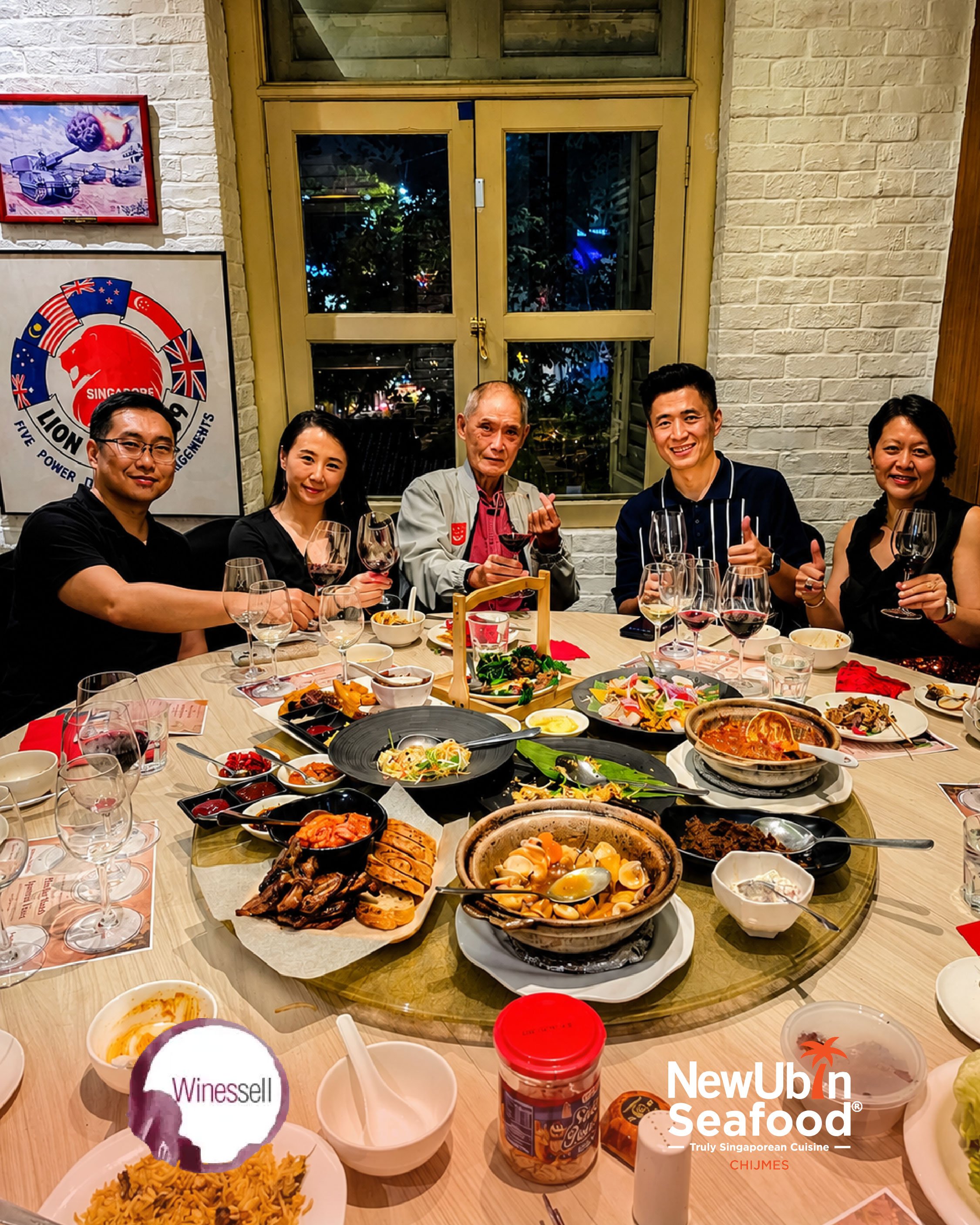People sitting around a dining table with various dishes including pasta, seafood, and desserts at CHIJMES during the Truly Singaporean Makan and Minum wine pairing event.